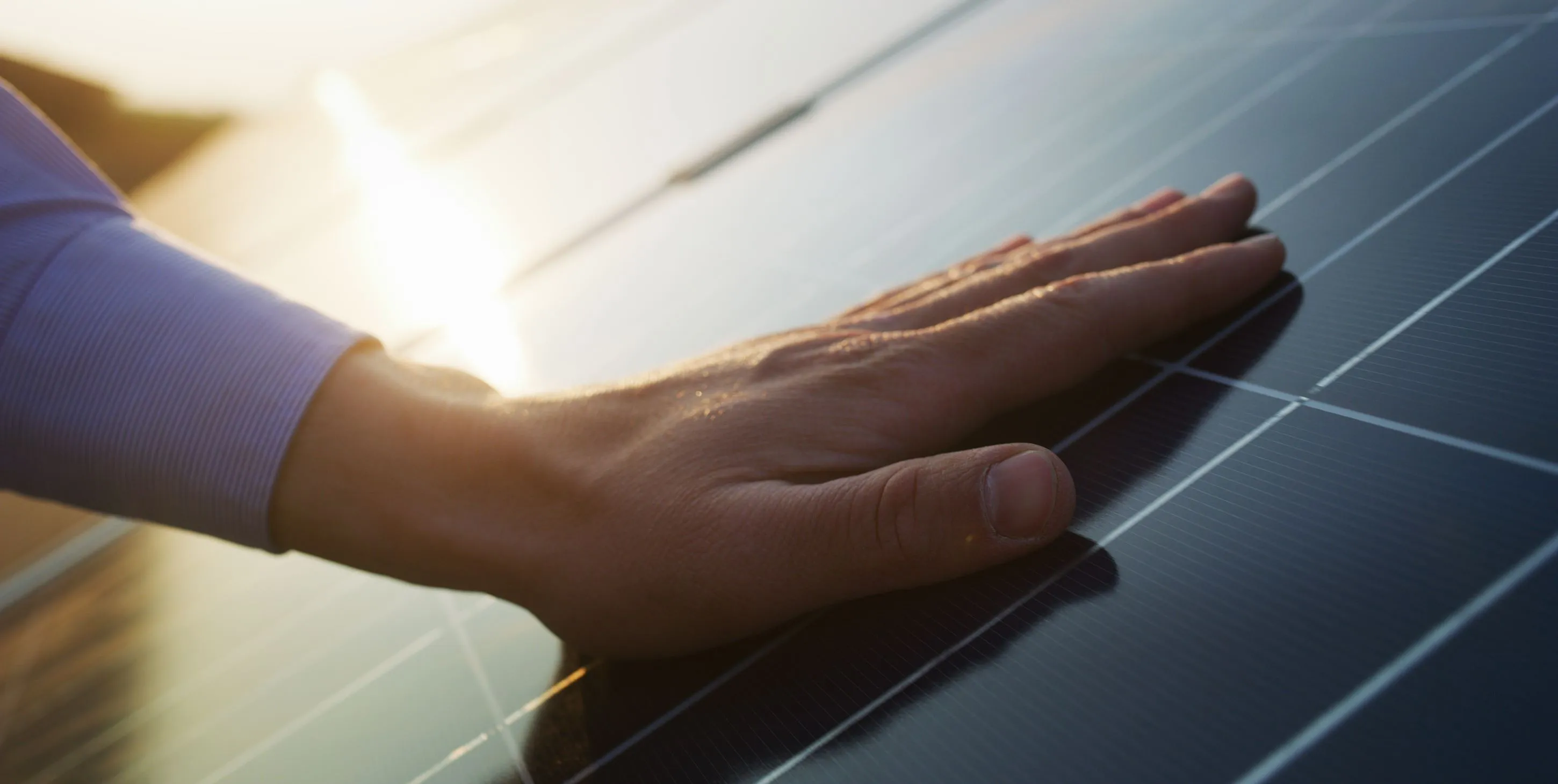 Hand on solar panel